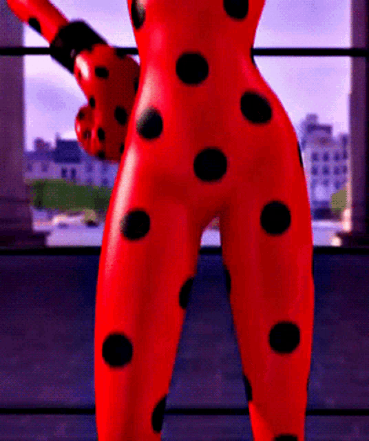 a ladybug statue with black polka dots on her pants