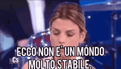 a woman with her eyes closed says ecco non e ' un mondo molto stabile .