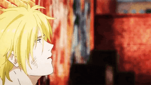 a close up of a person 's face with a yellow haired anime character .