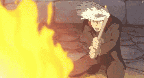 a man is kneeling down in front of a fire with a stick in his hand .