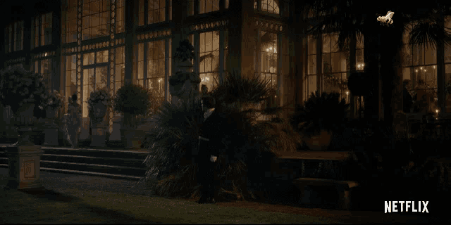 a netflix advertisement shows a man standing in front of a large building
