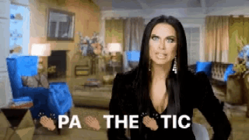a woman is standing in a living room with the words pa the tic on the bottom