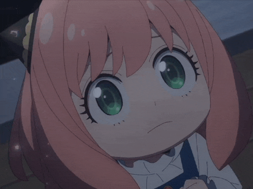 a little girl with pink hair and green eyes is looking at the camera