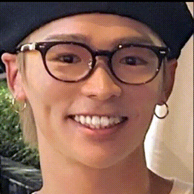 a close up of a person 's face with glasses and hoop earrings