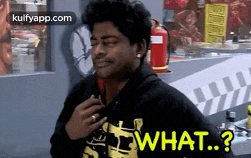 a man in a black hoodie is standing in front of a fire extinguisher and asking what ?