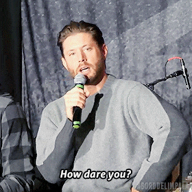 a man speaking into a microphone with the words how dare you below him