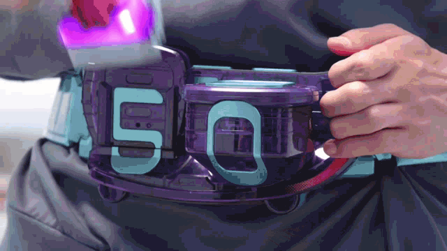 a person is wearing a purple belt with the number 5 on it