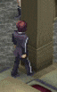 a man in a suit is standing next to a pillar .