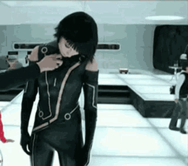a woman in a black suit is being helped by a man in a red jacket