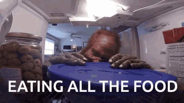 a picture of a monster in a refrigerator with the words eating all the food