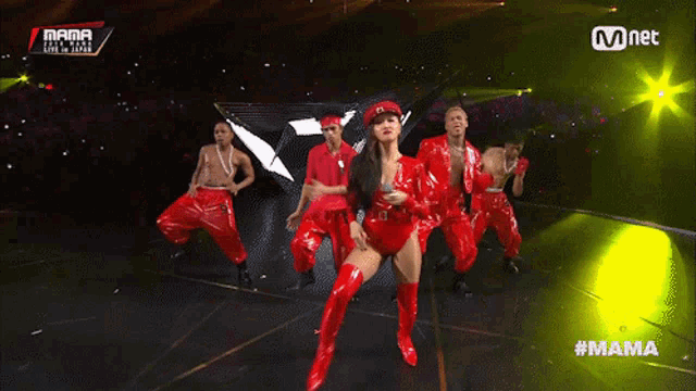 a group of people are dancing on a stage with the hashtag #mama