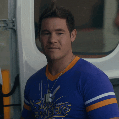 a man wearing a blue shirt that says ' smokers ' on it