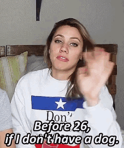 a woman wearing a sweatshirt that says don 't before 26 if i don 't have a dog