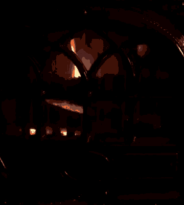 a fireplace is lit up in the dark and looks like a heart