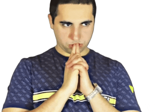 a man wearing a watch and a guess shirt holds his finger to his mouth