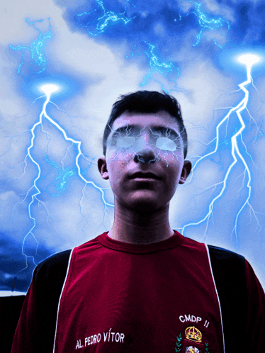 a man wearing a shirt that says al pedro vitor stands in front of a lightning storm