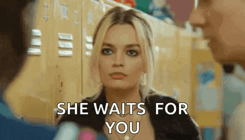 a woman is talking to a man in a locker room and says she waits for you .