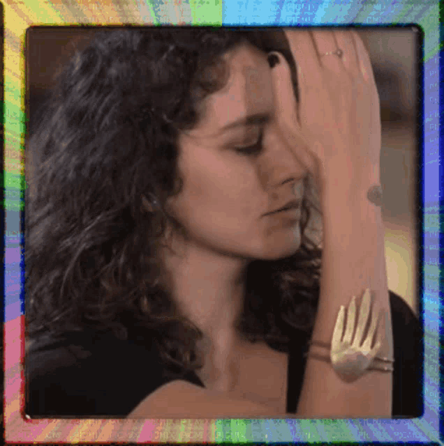 a woman with curly hair is wearing a bracelet with a fork on it
