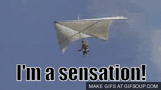 a shirtless man is holding a metal bar and says i 'm a sensation ..