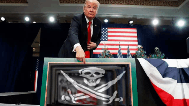 a man in a suit and tie points to a picture of a skull and crossbones
