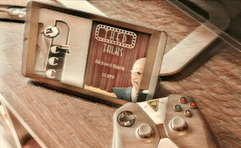 a video game controller sits on a wooden table next to a box that says richard blank