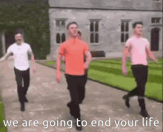 three men are walking down a sidewalk in front of a building with the words `` we are going to end your life '' .