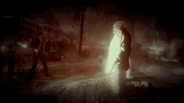 a man in a suit is standing in a dark forest with a light behind him