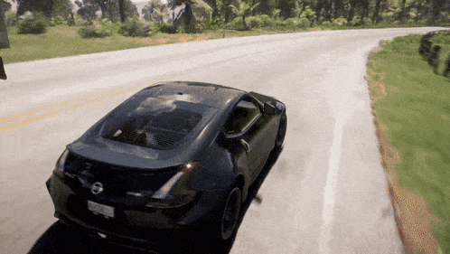 a nissan sports car is driving down a road with trees in the background