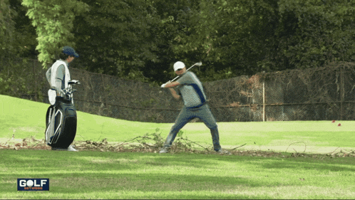 a man swings a golf club on a golf course with the word golf on the bottom