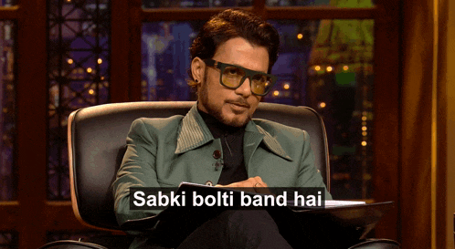 a man wearing glasses is sitting in a chair with the words sabki bolti band hai written on the bottom