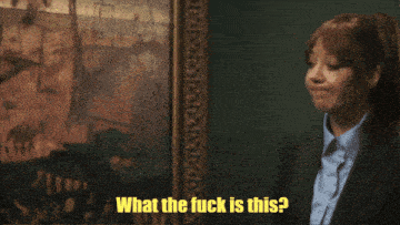 two women are looking at a painting with the words what the fuck is this
