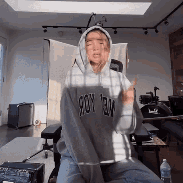 a woman wearing a hoodie that says joy ev