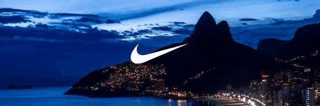 a picture of a city with a mountain in the background and a nike logo