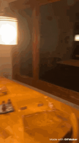 a blurred image of a bathroom with a sink , mirror , and lamp .