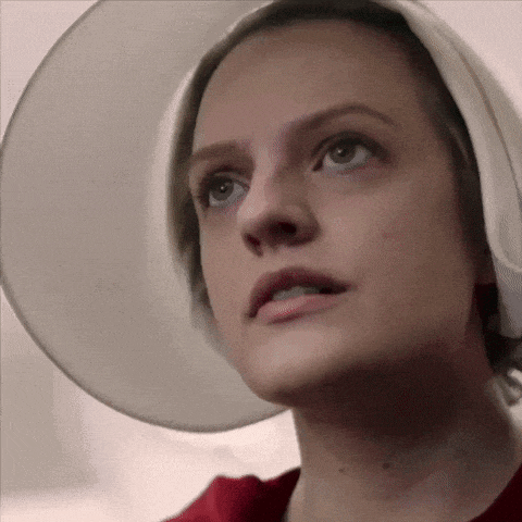 a close up of a woman 's face wearing a white hat .