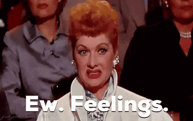 a woman with red hair is sitting in a crowd of people and says ew feelings .