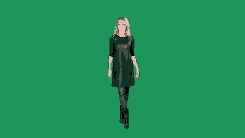 a woman in a black leather dress is walking on a green screen .