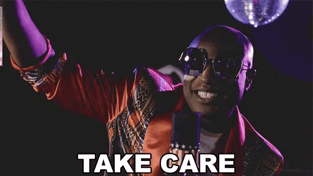 a man wearing sunglasses and a jacket with the words take care below him