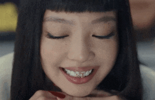 a close up of a woman 's face with her eyes closed and smiling .