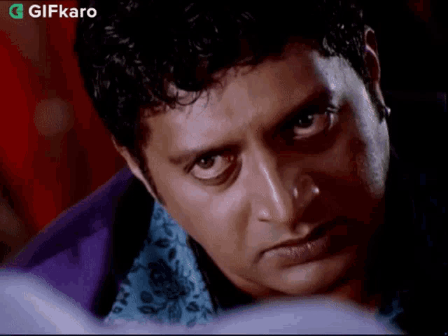 a close up of a man 's face looking at the camera .