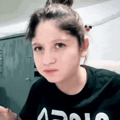 a young girl is wearing a black shirt with the word apollo on it .