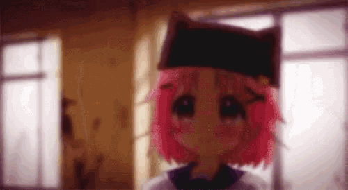 a girl with pink hair and a black hat is standing in front of a window in a room .
