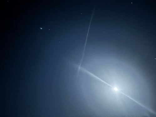 the sun is shining brightly in a dark night sky