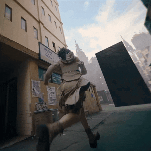 a woman running in front of a building that says dvd on it