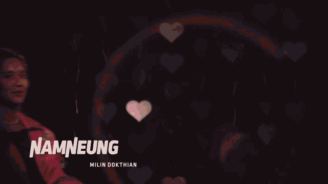 a woman in a pink jacket with the name namneung written on it