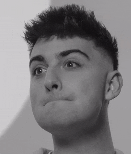 a close up of a young man making a face