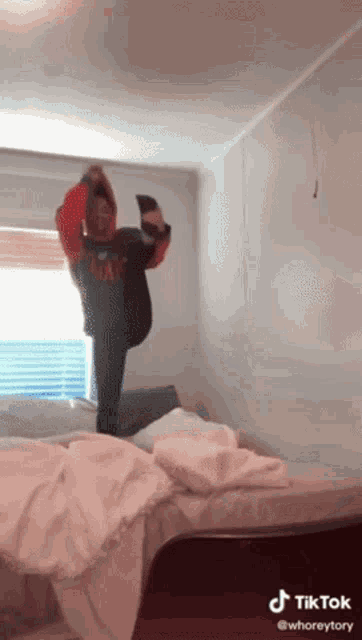 a person is doing a trick on a bed with a tik tok watermark