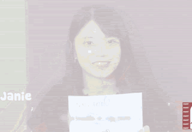a woman holds a piece of paper that says your smile