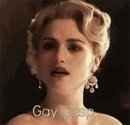 a close up of a woman 's face with the words gay gasp written below her