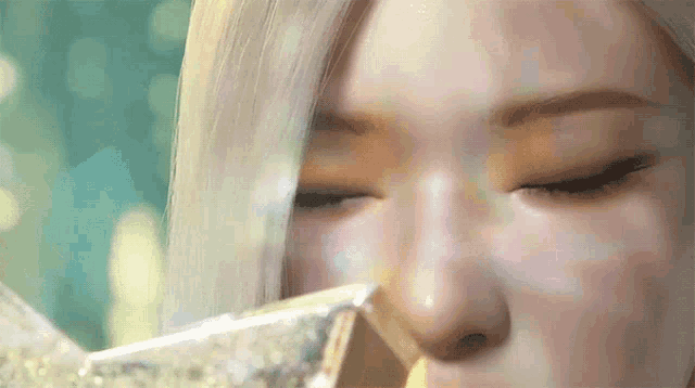 a close up of a woman 's face with a diamond in her nose
